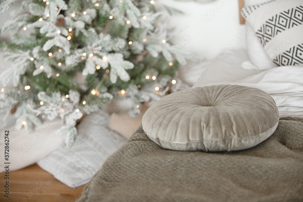 Pillows in the bedroom on christmas background. Cozy interior details. Skandi home. Pillows in the bedroom on christmas background. Cozy interior details. Skandi home.