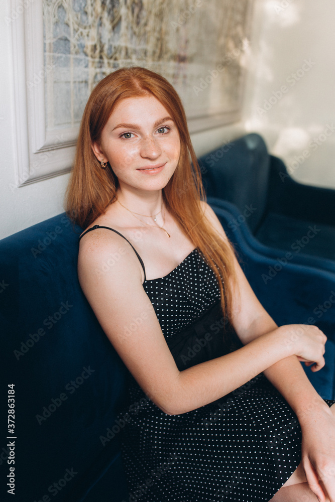 Fototapeta premium Young woman face with freckles, happy pretty caucasian ginger girl in cafe