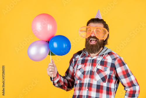 Looking good. funny man in birthday hat. happy holiday celebration. party goer going crazy. having fun with balloons. prepare for anniversary. best event manager. brutal male on party © be free