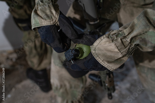Close-up grenade in the hands of an airsoft player © Павел Костенко