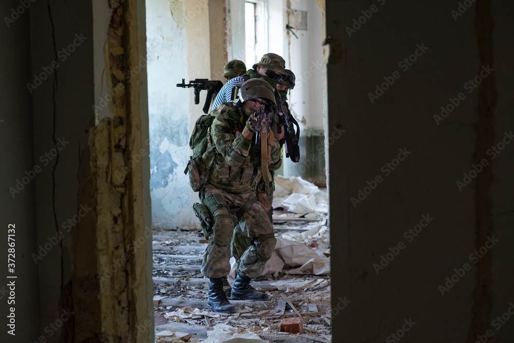 Fototapeta premium A team of professional airsoft players clear the location from opponents
