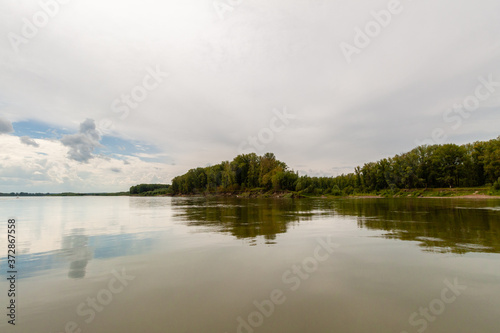 Siberian River Ob surrounded by Trees in Early morning in Russia in sunny weather during summer © Alexander Avsenev