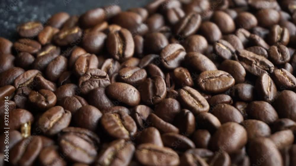 Coffee beans background. Making and roasting coffee beans for a drink. Food and drinks video, top view Coffee beans background. Making and roasting coffee beans for a drink. Food and drinks video, top view