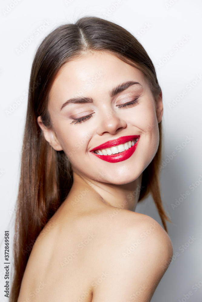 Charming woman Eyes closed smile red lips bare shoulders light Charming woman Eyes closed smile red lips bare shoulders light