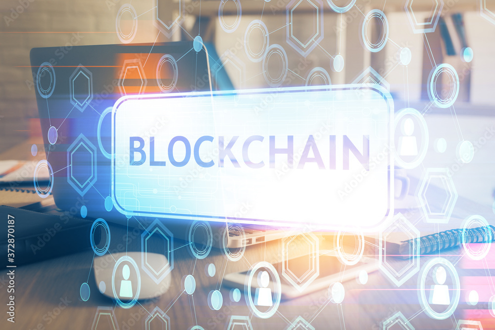 Multi exposure of blockchain theme hologram and table with computer background. Concept of bitcoin crypto currency. Multi exposure of blockchain theme hologram and table with computer background. Concept of bitcoin crypto currency.