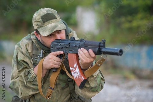 A professional airsoft player aims at his opponents