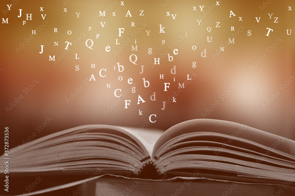 custom made wallpaper toronto digitalOpen book on the table and English alphabet Floating above the book in the library and blur bookshelf background.