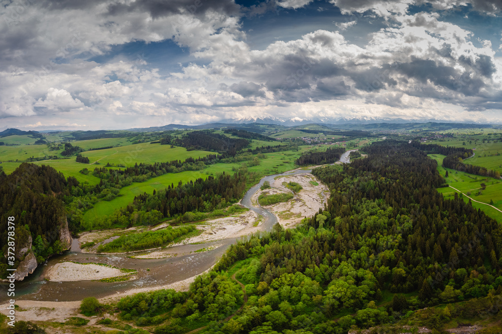 Obraz premium Drone photo of Bialka River with view to the Tatra Mountains- spring season with pretty colours
