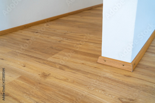 Home wood laminate flooring background. Light wooden textured interior house floor.