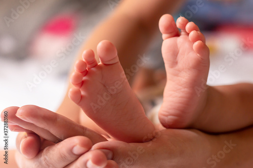 Newborn baby feet on a white blanket.