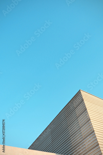 Vertical minimal urban background. Look up to modern building with guided lines