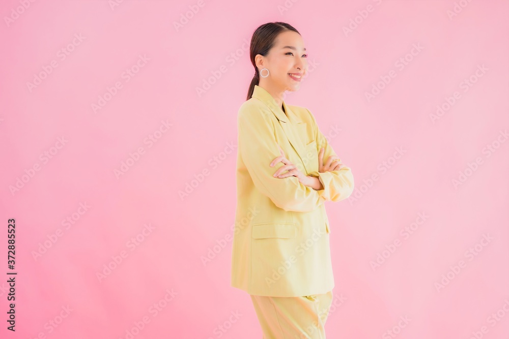 Portrait beautiful young asian business woman smile in action on pink color Portrait beautiful young asian business woman smile in action on pink color