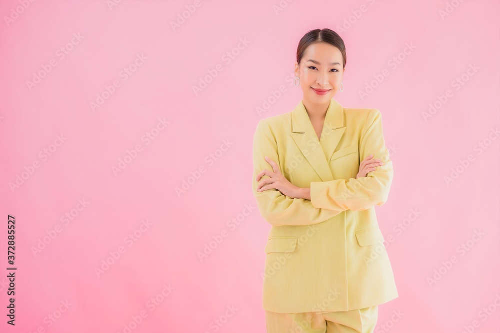 Portrait beautiful young asian business woman smile in action on pink color Portrait beautiful young asian business woman smile in action on pink color