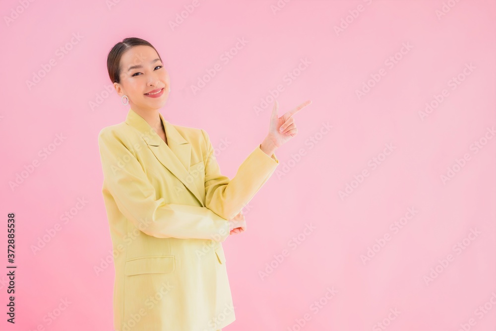 Portrait beautiful young asian business woman smile in action on pink color Portrait beautiful young asian business woman smile in action on pink color