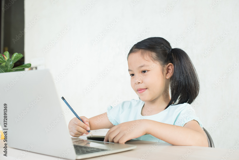 pretty stylish schoolgirl studying homework during online lesson at home, social distance during quarantine, self-isolation, online education concept, home school, study online video call teacher. pretty stylish schoolgirl studying homework during online lesson at home, social distance during quarantine, self-isolation, online education concept, home school, study online video call teacher.