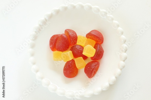 Canvastavla red and yellow gummy jelly candy on white dish