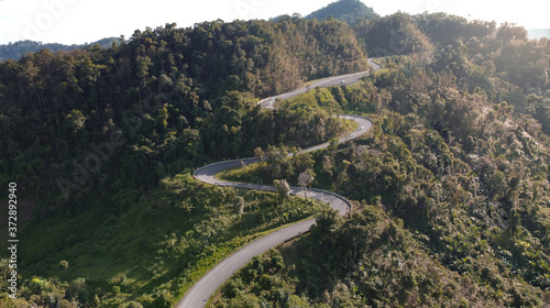 Nan, Thailand. Aerial view of Beautiful sky road over top of mountains with green jungle. Road trip on curve road in mountain.