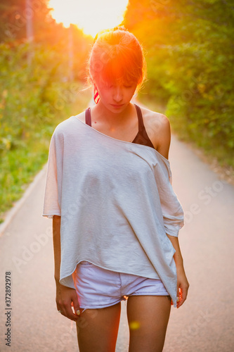 Portrait of a young woman in the summer at sunset