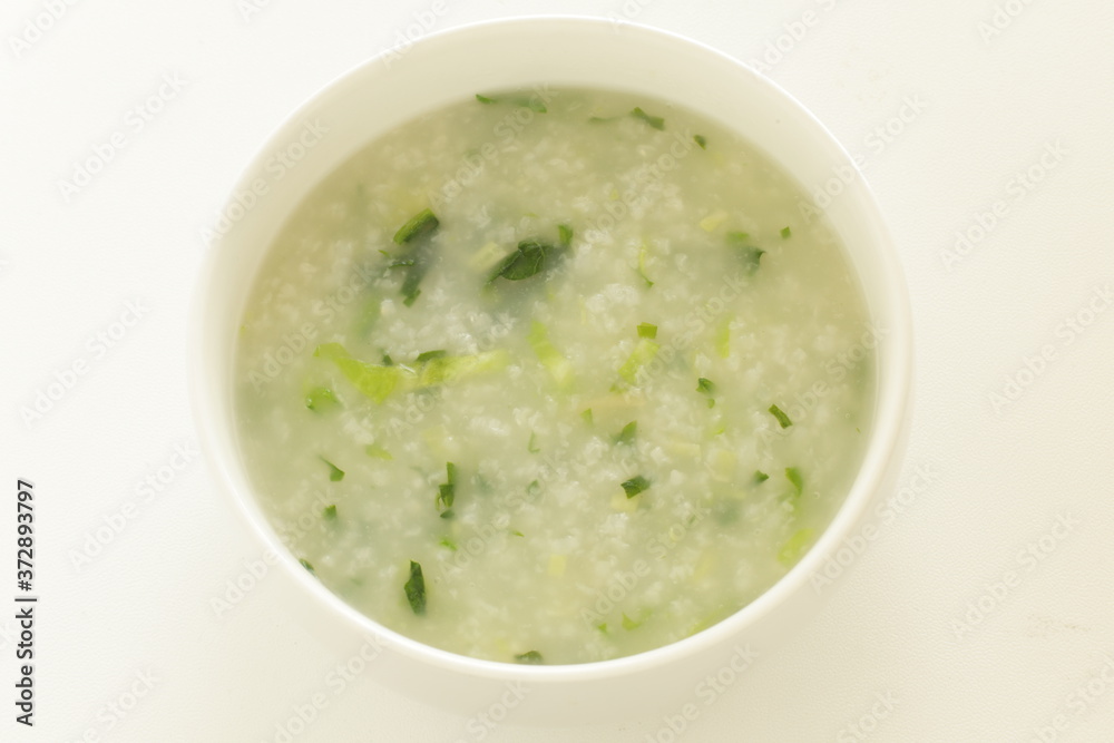 Chinese food, spinach and rice porridge in white bowl Chinese food, spinach and rice porridge in white bowl