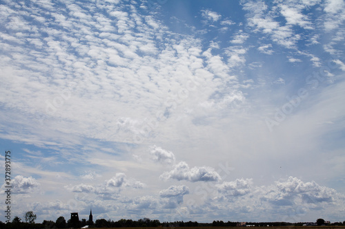 Landscape with blue sky and unique clouds.