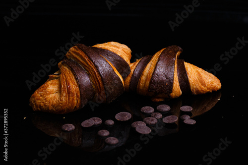 Croissants with chocolate. Homemade pastries, croissants decorated with chocolate.