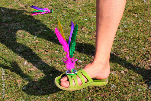 Foto Jianzi, traditional Chinese shuttlecock with four feathers fixed into a rubber s