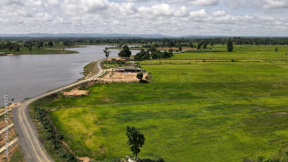 High angle shot river flows through the rice fields. High angle shot river flows through the rice fields.