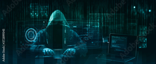 hooded hacker performing an security breach photo