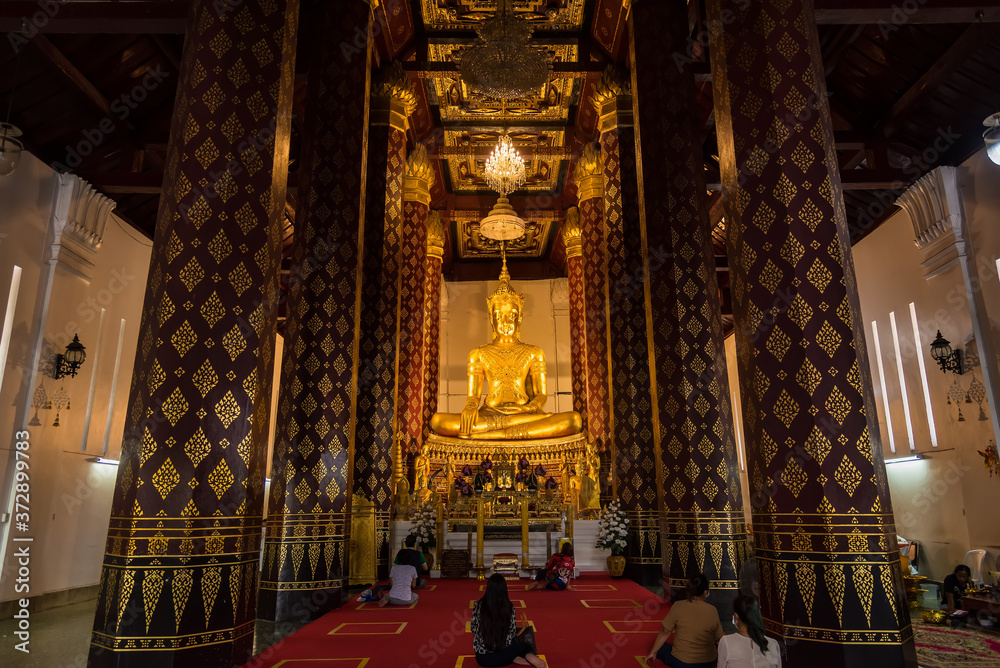 Fototapeta premium Ayutthaya, Thailand - June, 22, 2020 : Golden buddha image in ancient temple in Ayutthaya , Thailand