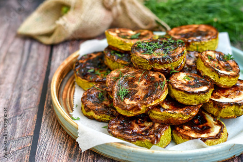 Home made  organic fried zucchini with  garlic yogurt sauce on wooden background photo