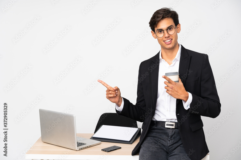 Businessman in his office over isolated white background pointing finger to the side Businessman in his office over isolated white background pointing finger to the side