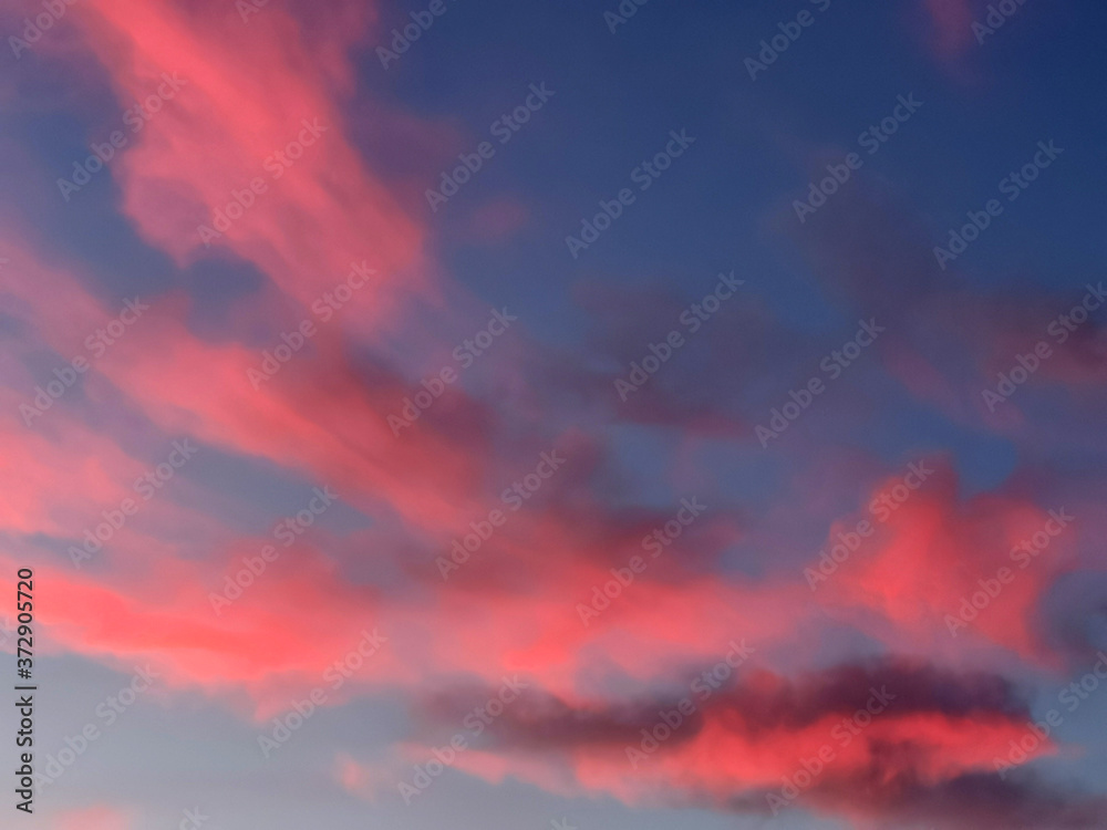 Beautiful vanilla sky with pink and red clouds over the roof