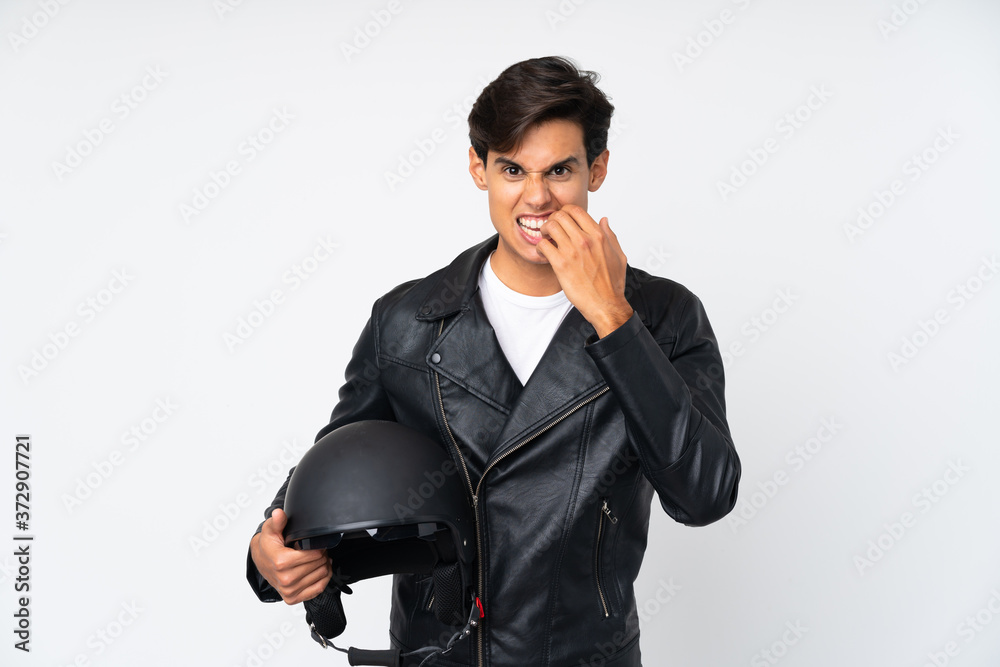Man holding a motorcycle helmet over isolated white background nervous and scared Man holding a motorcycle helmet over isolated white background nervous and scared
