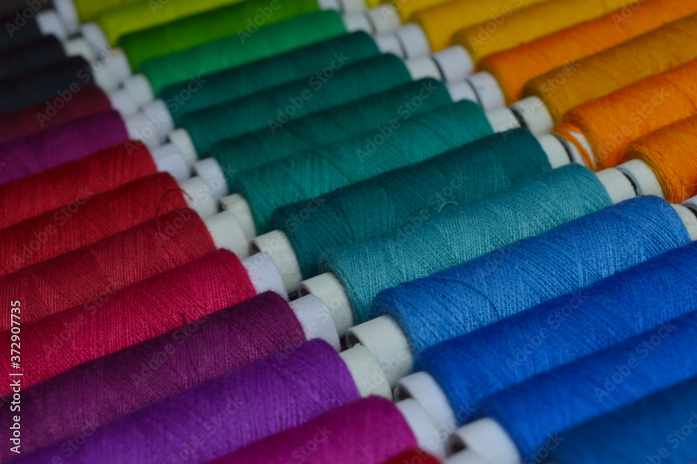 colourful thread rolls arranged in a box colourful thread rolls arranged in a box