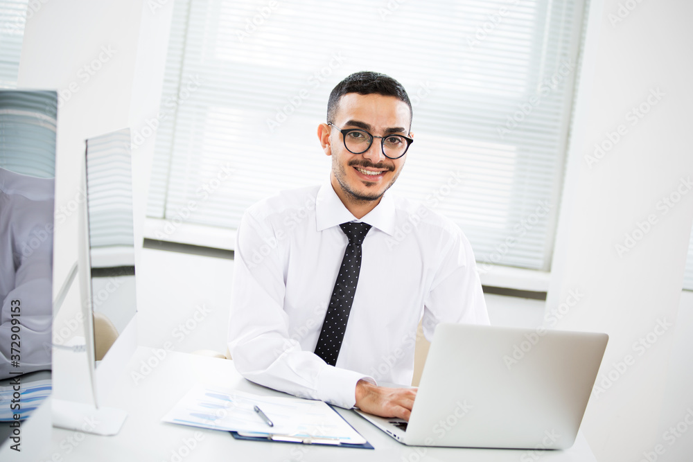 Happy arab businessman smiling while looking at camera in office Happy arab businessman smiling while looking at camera in office