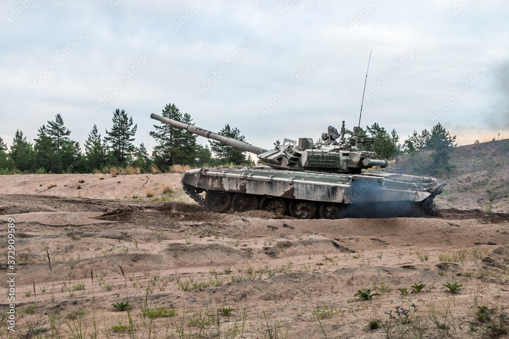 battle tank attacks the enemy on the road through the forest battle tank attacks the enemy on the road through the forest