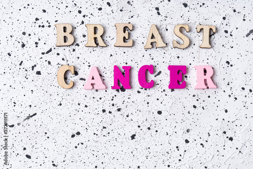 Fototapeta premium Breast Cancer word on white cement background.Breast cancer.