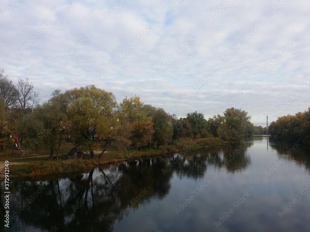 Beautiful autumn landscape forest and river with water reflection day light  Sumy region Ukraine