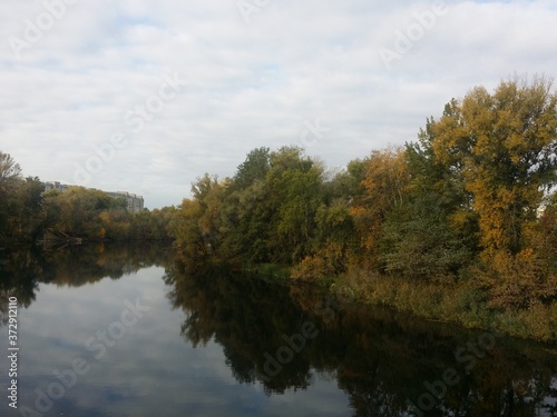 Beautiful autumn landscape forest and river with water reflection day light Sumy region Ukraine