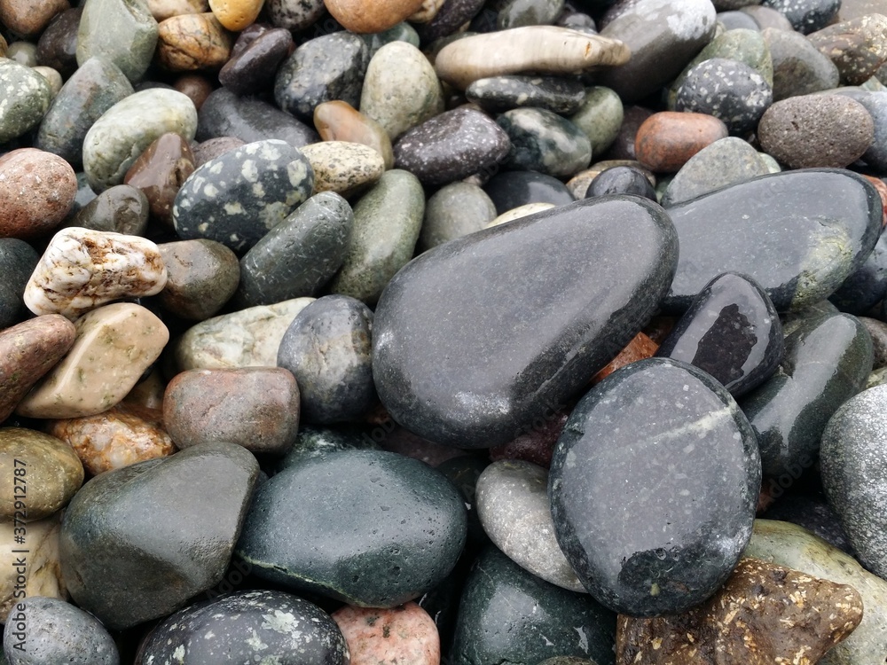 wet sea stones small rocks natural background seascape vacation concept wallpaper texture close up selective focus wet sea stones small rocks natural background seascape vacation concept wallpaper texture close up selective focus