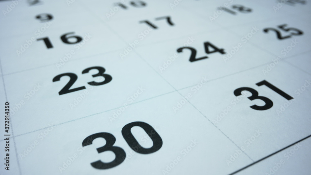 Business calendar for event planning. Female hand marking date on calendar Business calendar for event planning. Female hand marking date on calendar