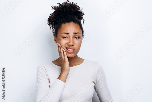 Obraz na plátně African american girl standing over isolated white background touching mouth wit