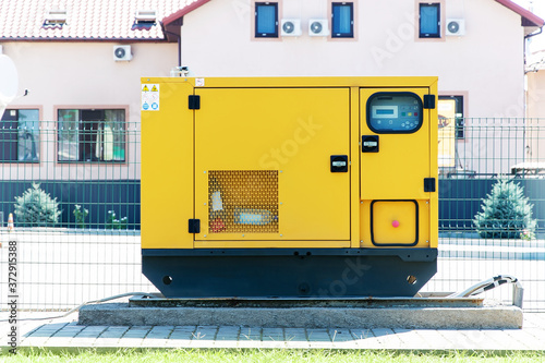 Power diesel stationary street generator on the background of the building.