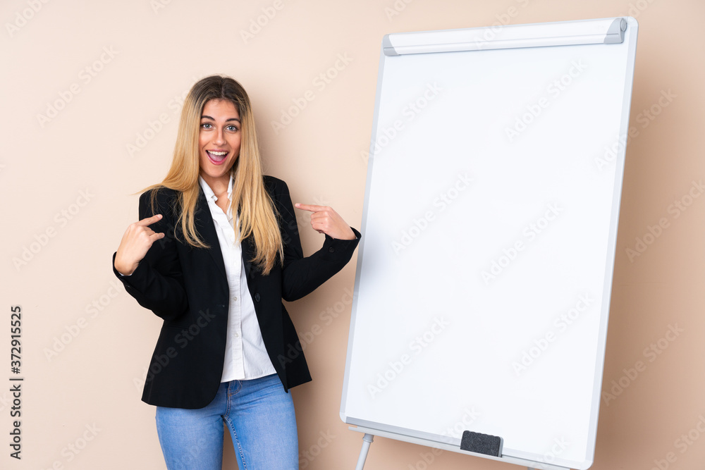 Young Uruguayan woman giving a presentation on white board and with surprise expression Young Uruguayan woman giving a presentation on white board and with surprise expression