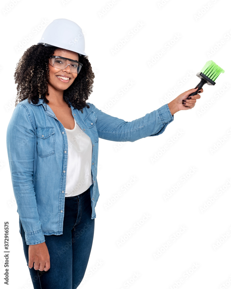 Cheerful and smiling Brazilian black woman isolated on white background, working with a brush wearing glasses and helmet on her head Cheerful and smiling Brazilian black woman isolated on white background, working with a brush wearing glasses and helmet on her head