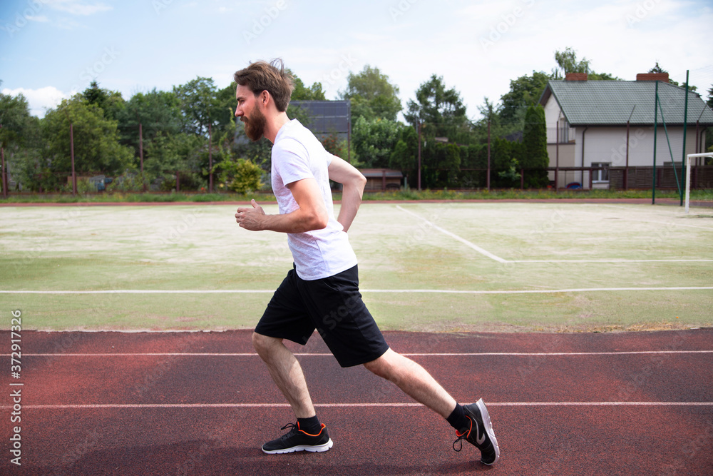 Sprinter training on a running track. Sprinter training on a running track.