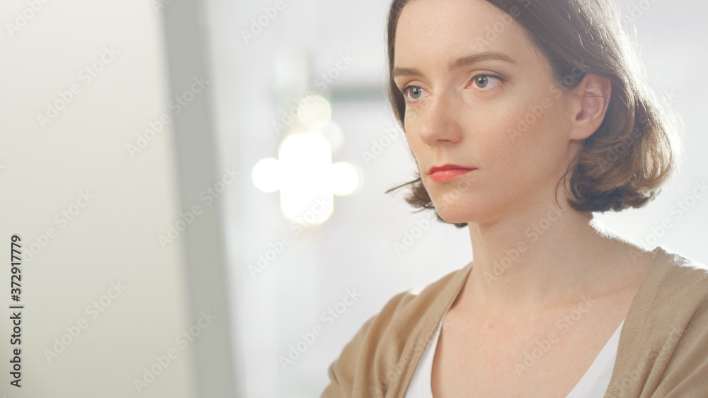 Close-up Portrait Shot of Beautiful Creative Woman Sits at Her Office and Working On a Personal Computer.