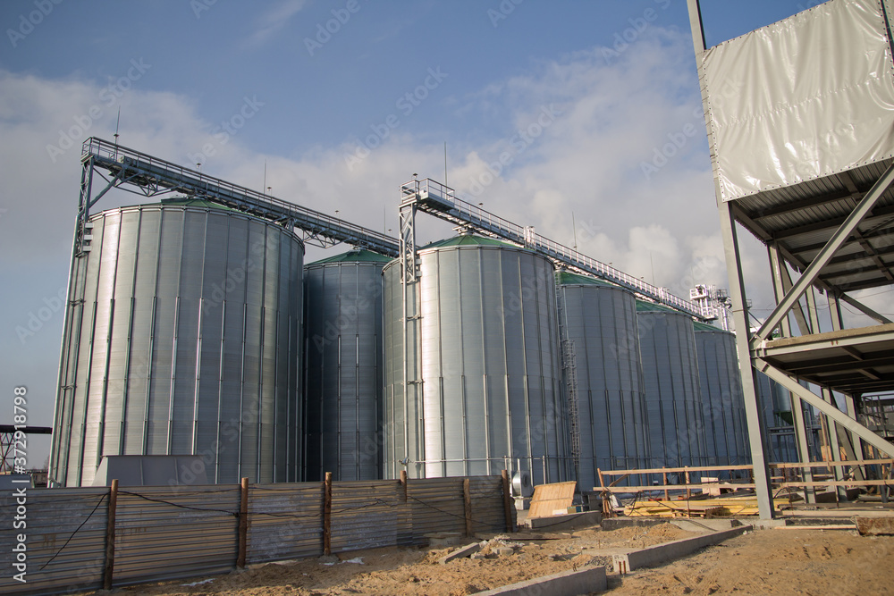 Construction of a feed mill agro-processing plant for processing and silos for drying cleaning and storage of agricultural products, flour, cereals and grain. Close-up.