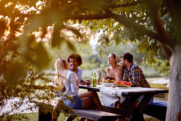 cheerful friends having  at party outdoor,talking and laughing enjoying at friendship.