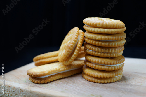 Stack of buttercream crackers against black background